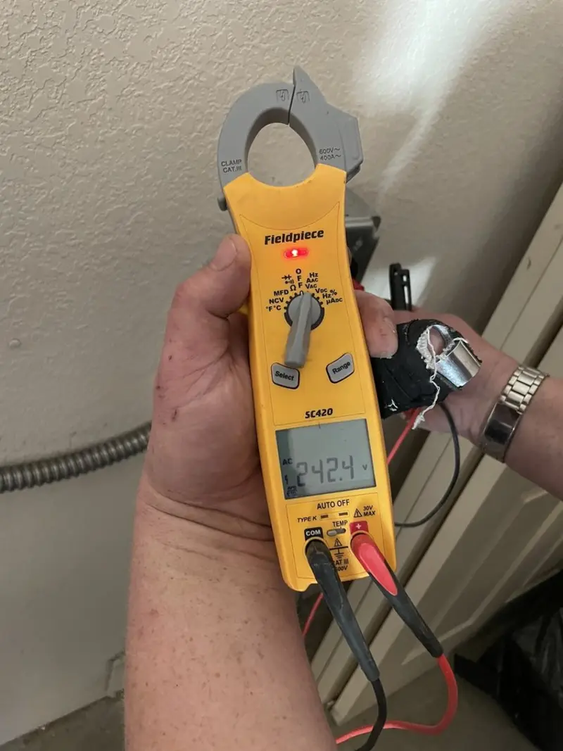 Voltage testing with clamp meter during Outlet Installation in Pensacola